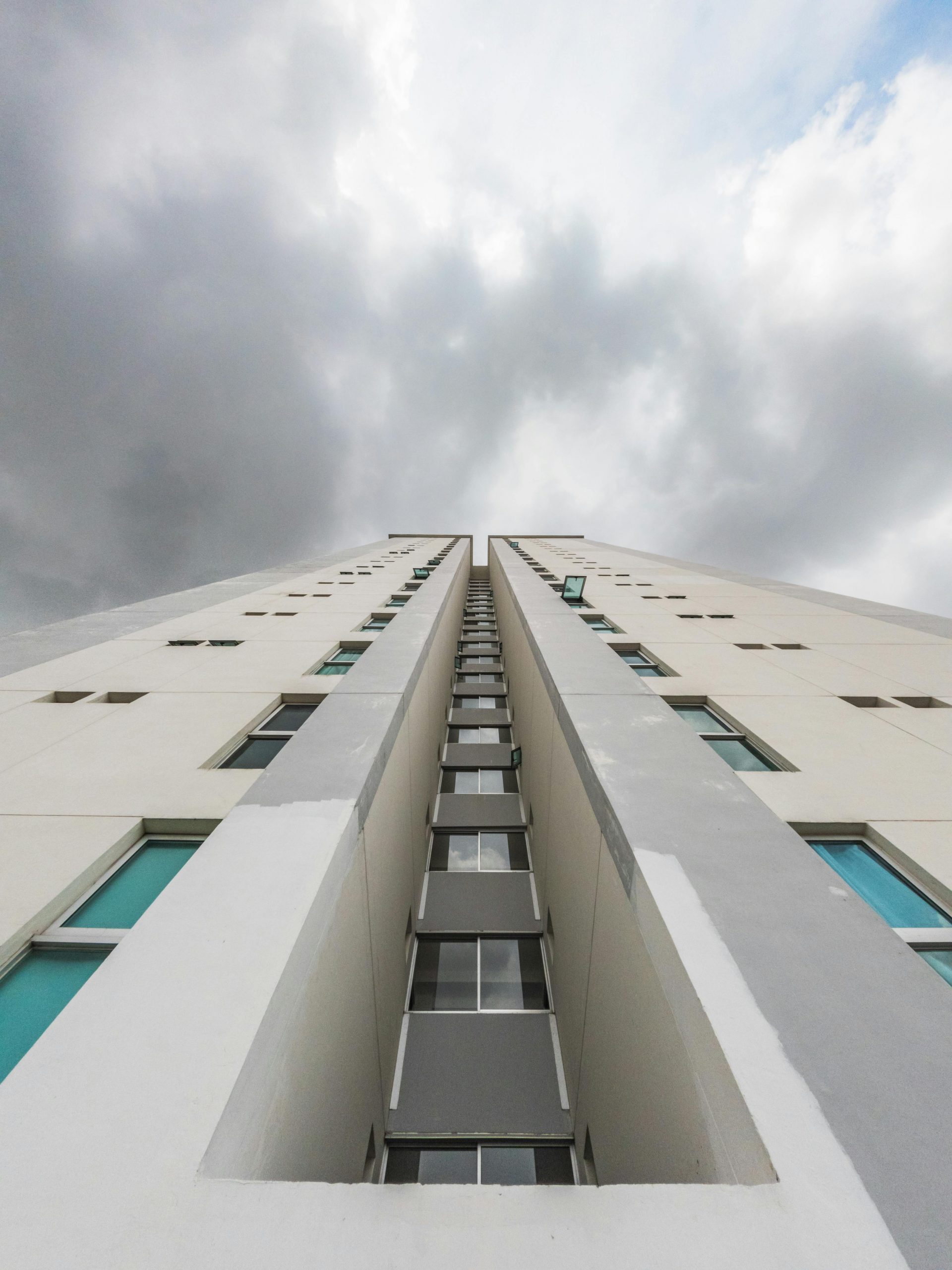 Low-angle view of a modern skyscraper against a dramatic sky in Panama City, Panama.